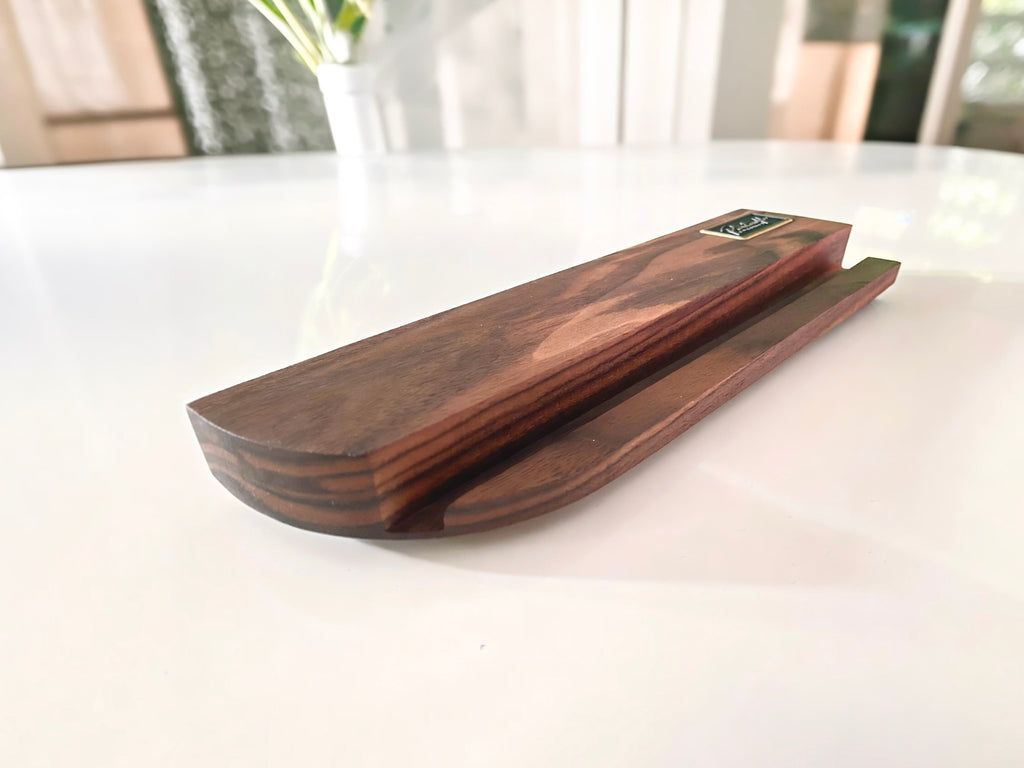 Curved end and bevel of the walnut now playing stand