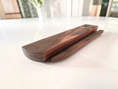 Curved end and bevel of the walnut now playing stand