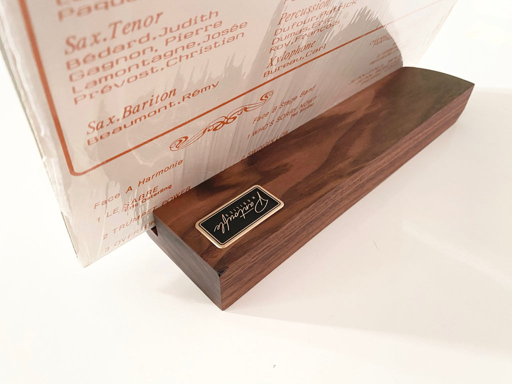 Now playing stand holding an album sleeve, seen from the side